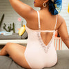 Peach-colored Brigitte V-neck one-piece swimsuit by Parfait Lingerie with lace detail, shelf bra, and full coverage.